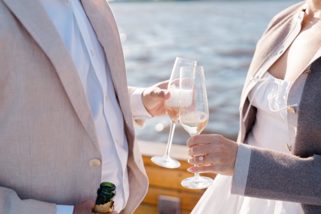 Couple sharing a glass of champagne during engagement session at Sea Philly