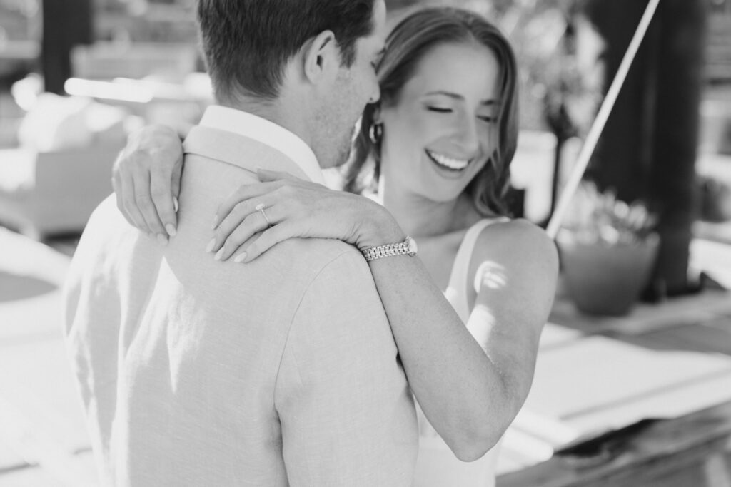 black and white image of couple laughing together during engagement session at Sea Philly