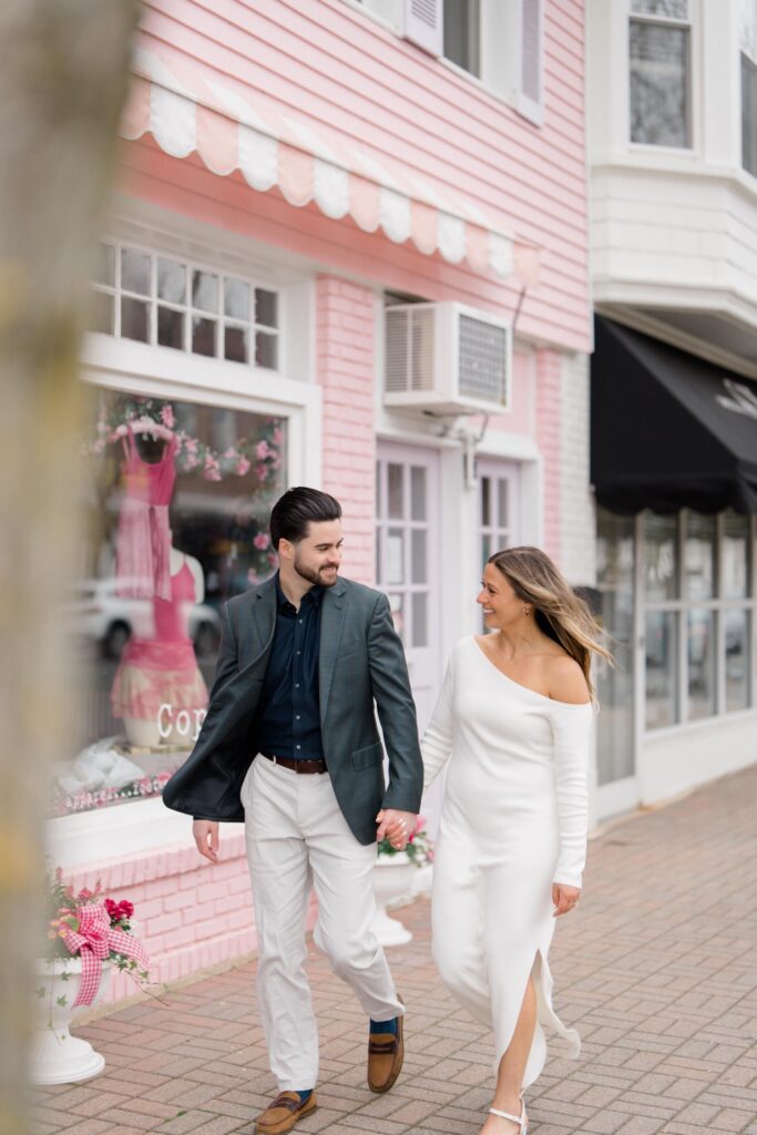 Couple walking together outside a pink shop in Spring Lake