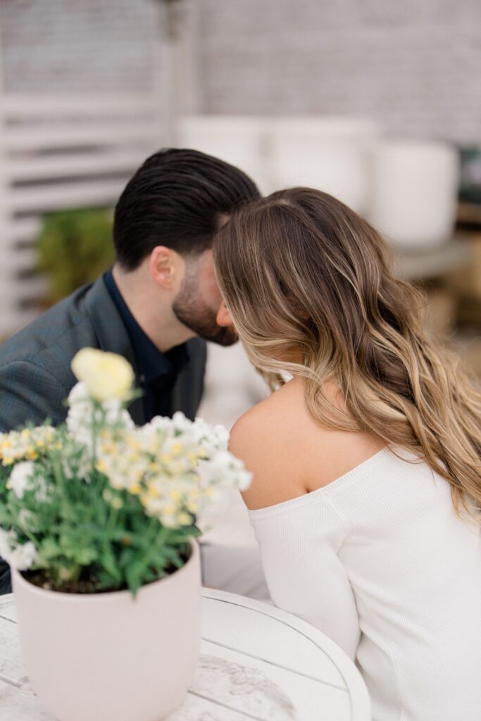 Groom whispering in brides ear during Spring Lake Engagement
