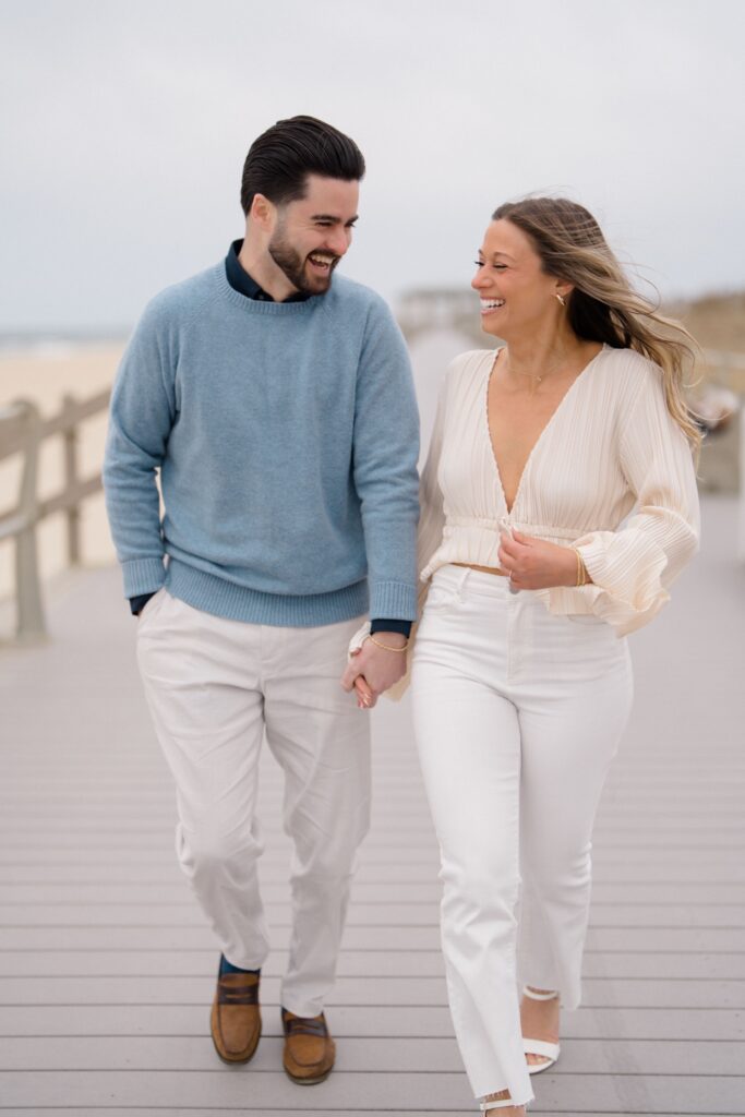 Bride & Groom walking together on the boardwalk during Spring Lake Engagement